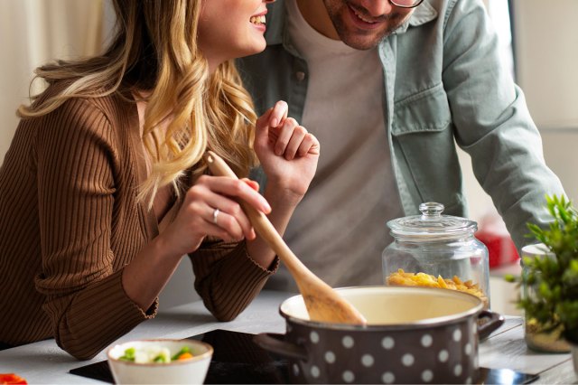 An image of a woman and a man cooking