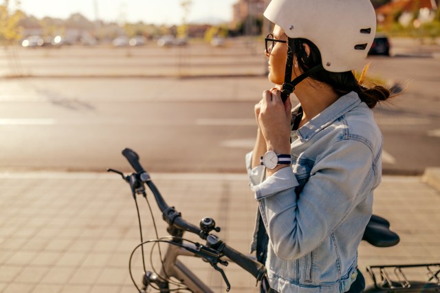 An image of a woman on a bike with a white helmet