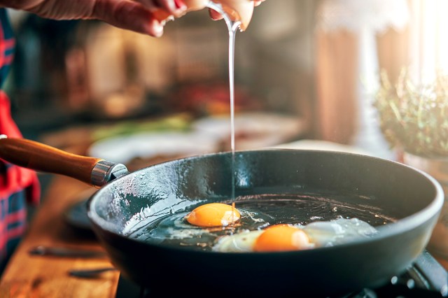 An image of two eggs in a cast-iron skillet