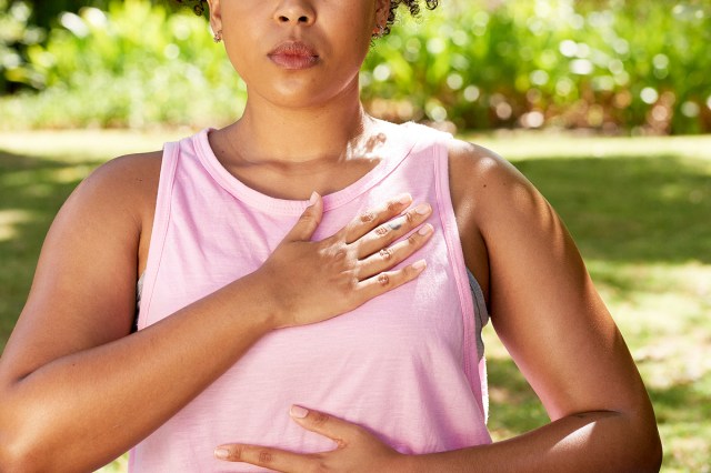 An image of a woman with her hands over her heart and stomach