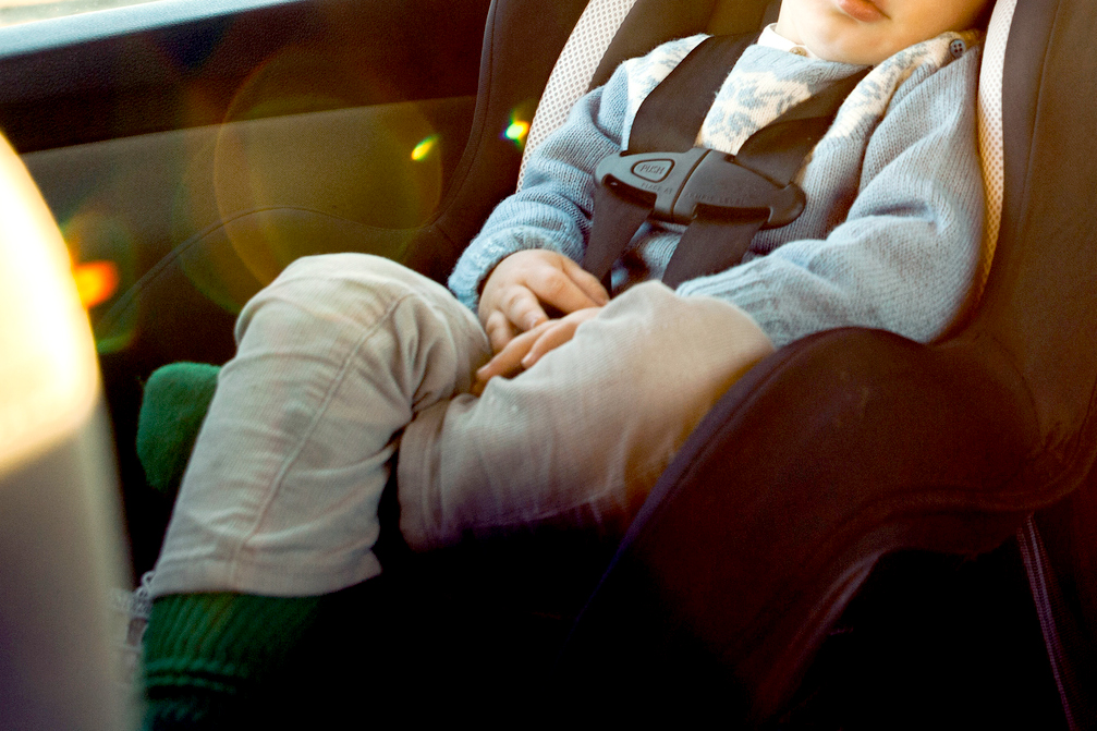 An image of a child sleeping in a car seat