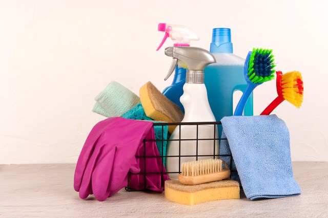 A wire basket of cleaning supplies
