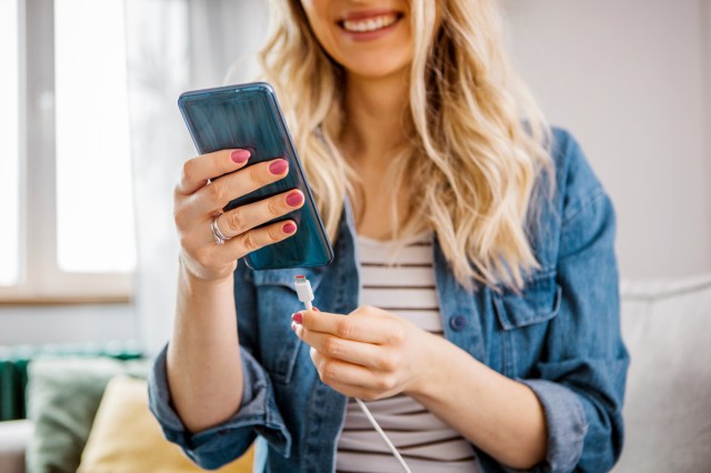 An image of a woman plugging in her phone