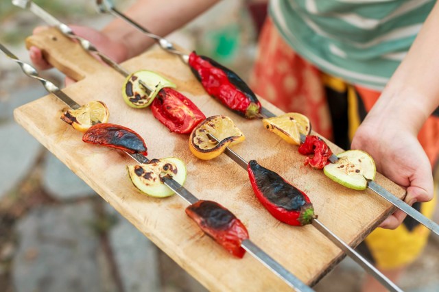 An image of skewers of vegetables on a cutting board
