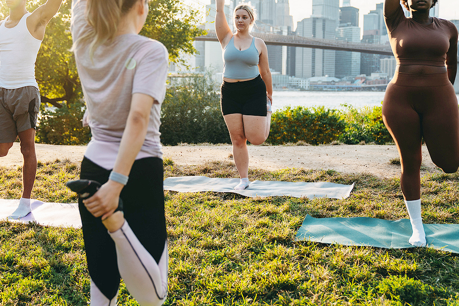 An image of women doing yoga in a park