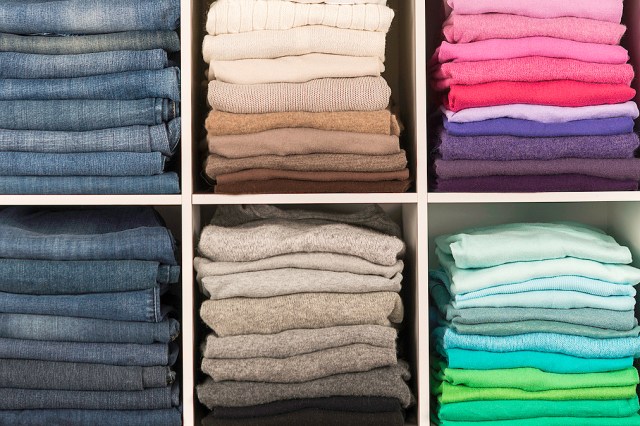 Colorful towels folded on a bookshelf