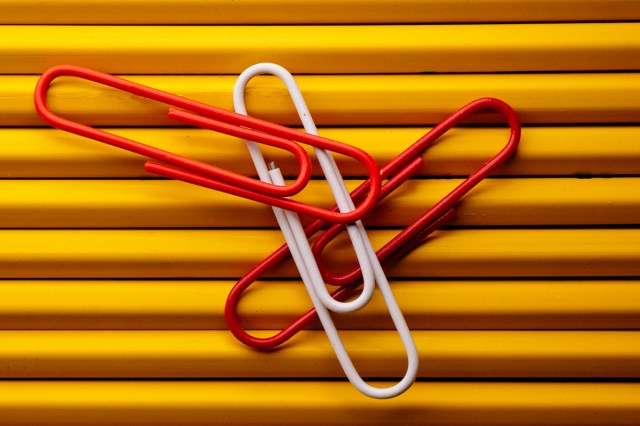An image of red and white paperclips against a gold background