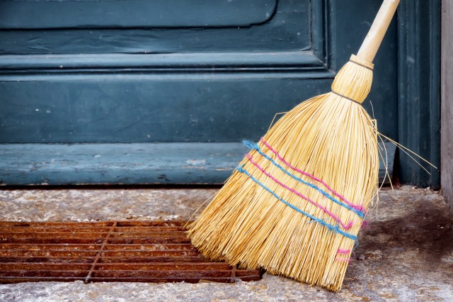 An image of a broom in front of a door