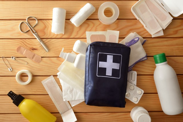 An image of a first aid kid with its contents around it