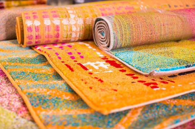 An image of several multi-colored rugs