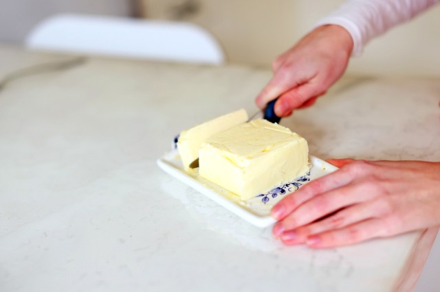 An image of a person slicing butter
