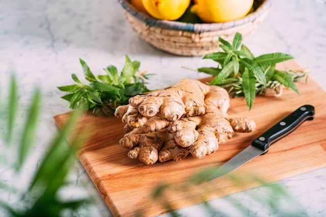 An image of ginger root on a wood cutting board