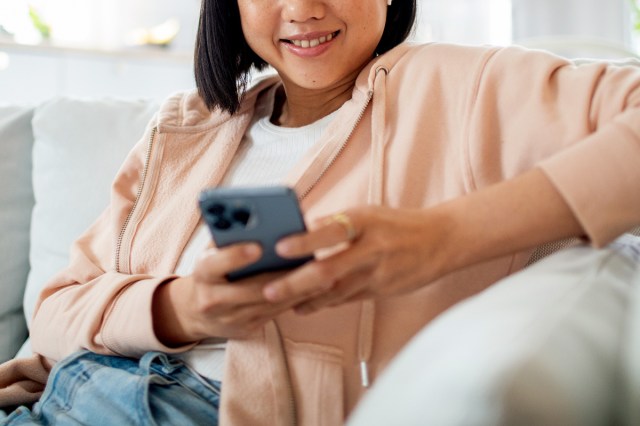 An image of a woman holding a cell phone