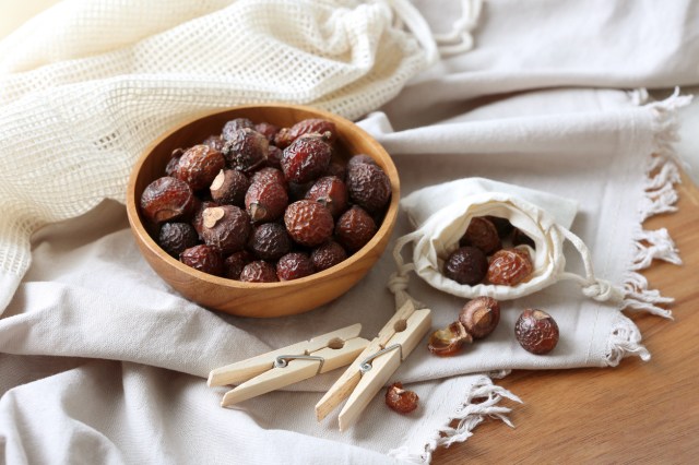 An image of a bowl of soap nuts on a white cloth