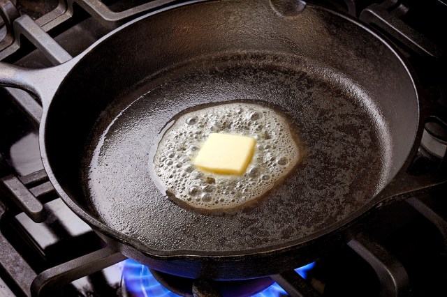 An image of butter melting in a cast-iron skillet