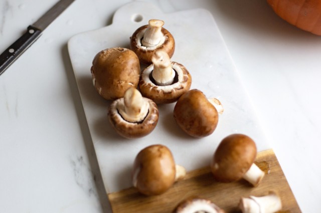 An image of mushrooms on a cutting board