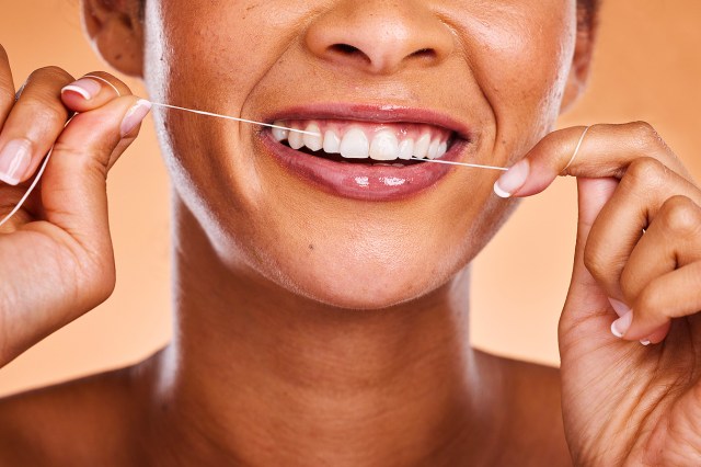 An image of a woman flossing