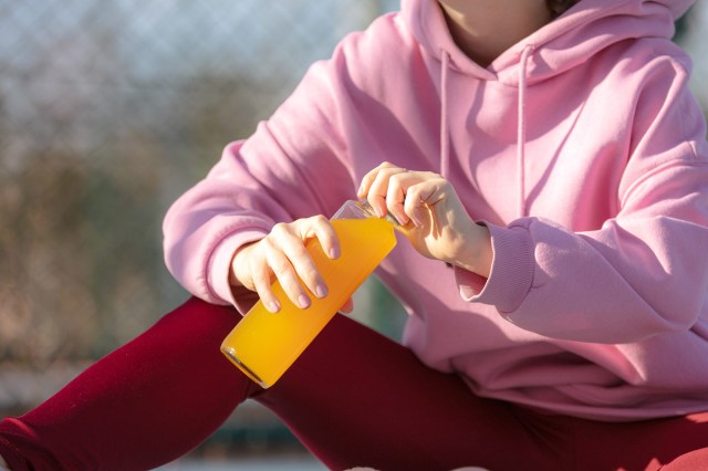 An image of a woman holding a sports drink