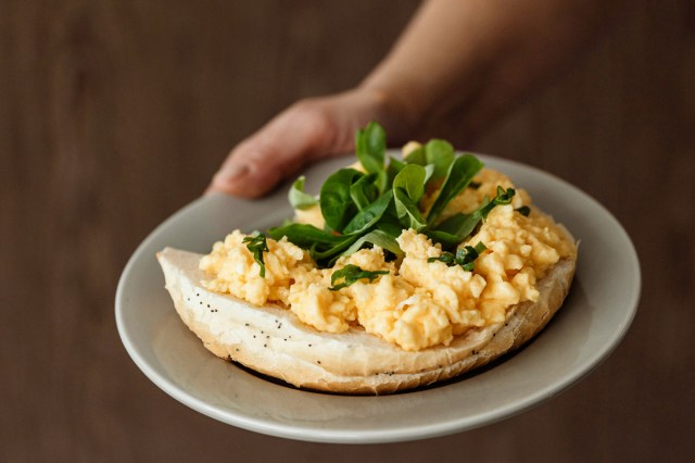 An image of eggs on bagel on a plate