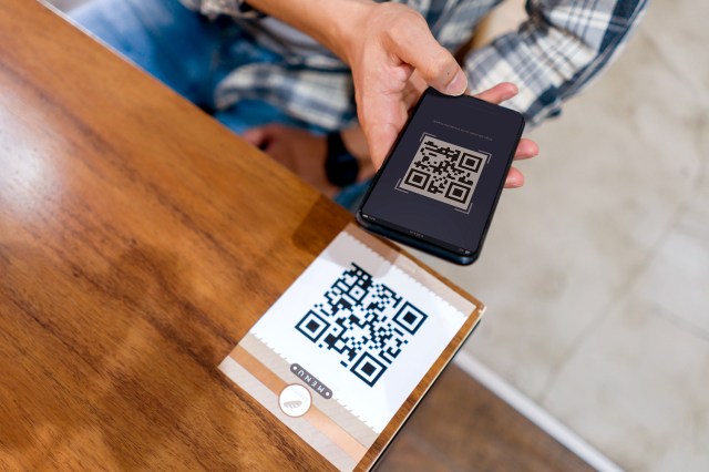 An image of a person scanning a QR code with their phone