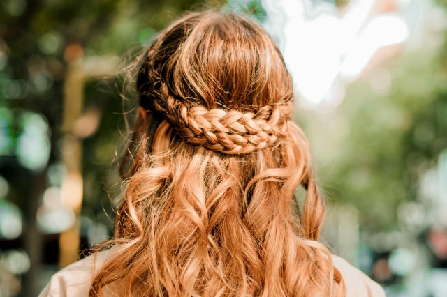 An image of a red-headed women with braids in her hair