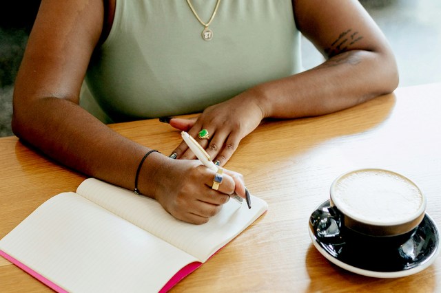 An image of a woman writing in a notebook