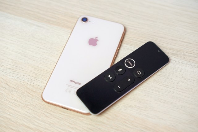 An image of an iPhone and an Apple TV remote