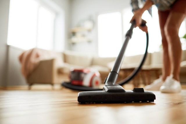 An image of a woman vacuuming 