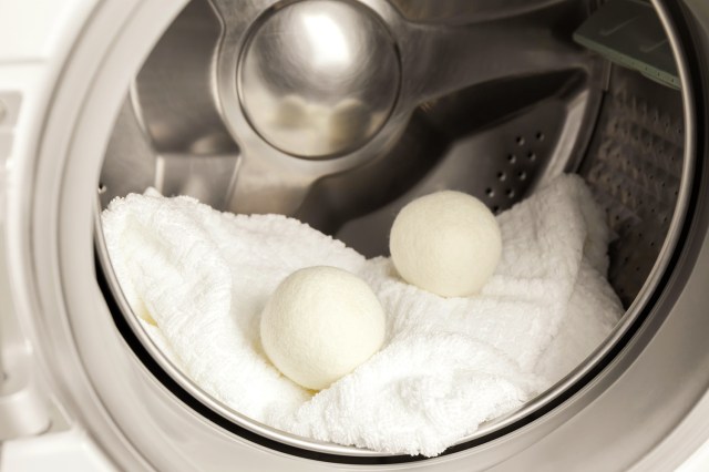 An image of a dryer balls and a white blanket in the dryer