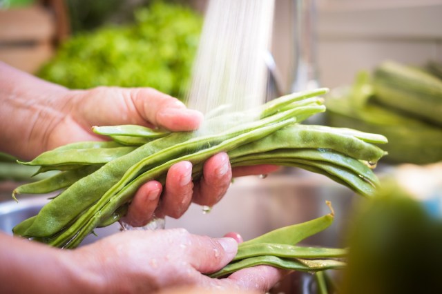 An image of a person washing green beans