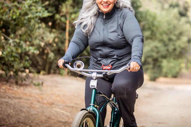 An image of a woman riding a bike