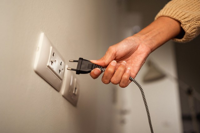 An image of a person unplugging a cord