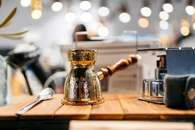 An image of a cezve on the table in a coffee shop 