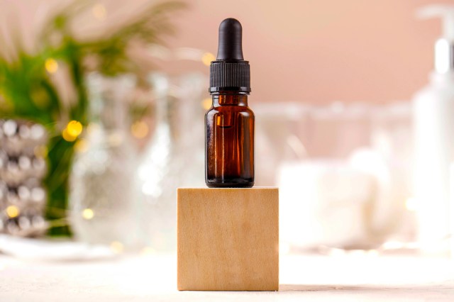 An image of an essential oil bottle on a wooden block