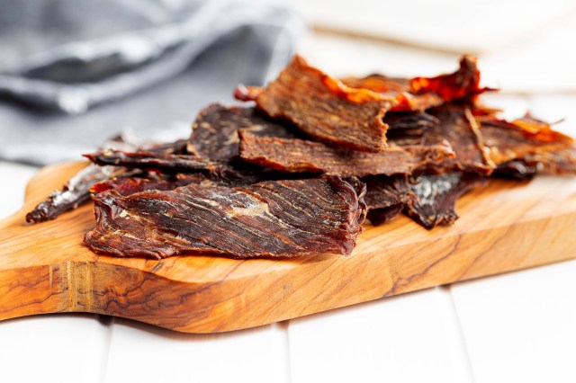 An image of a beef jerky on a cutting board