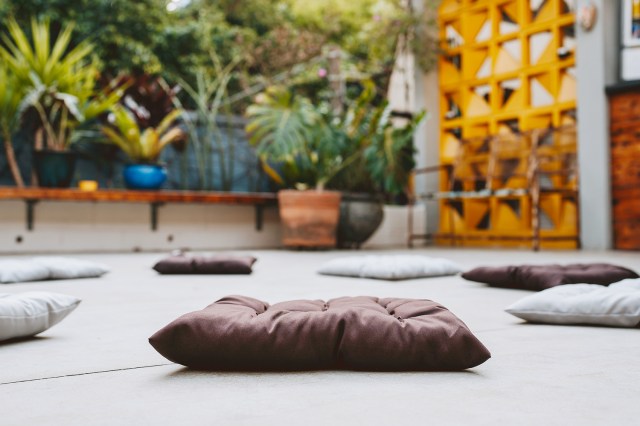 An image of floor cushions in a circle on the floor