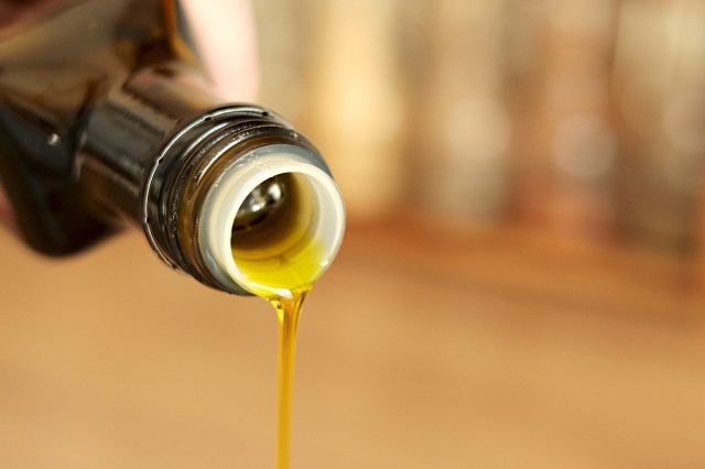 Olive oil being poured out of a bottle