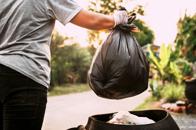 An image of a person taking out the trash