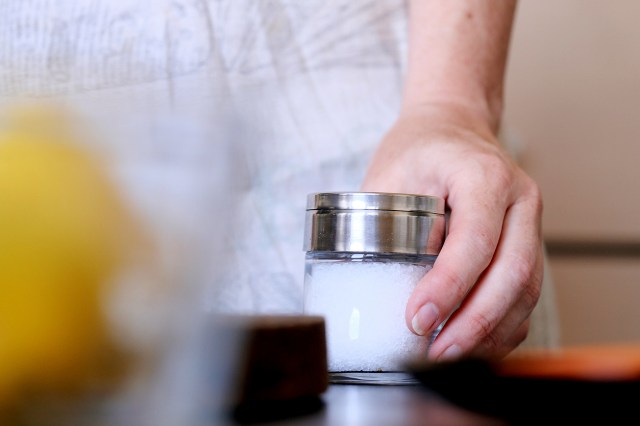 An image of a person holding a jar of salt