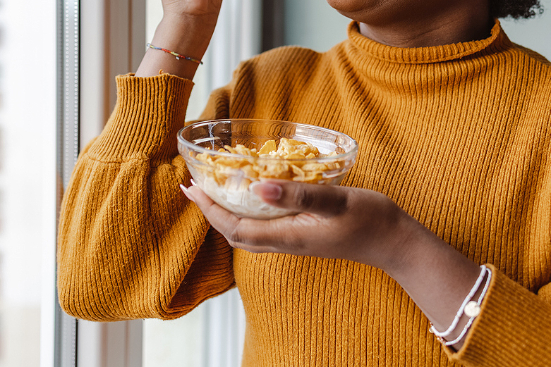 An image of a woman holding a bowl of cereal