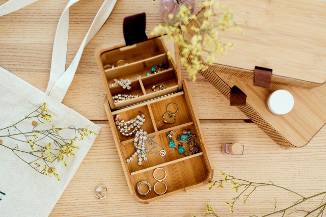 An image of an open jewelry box with small compartments