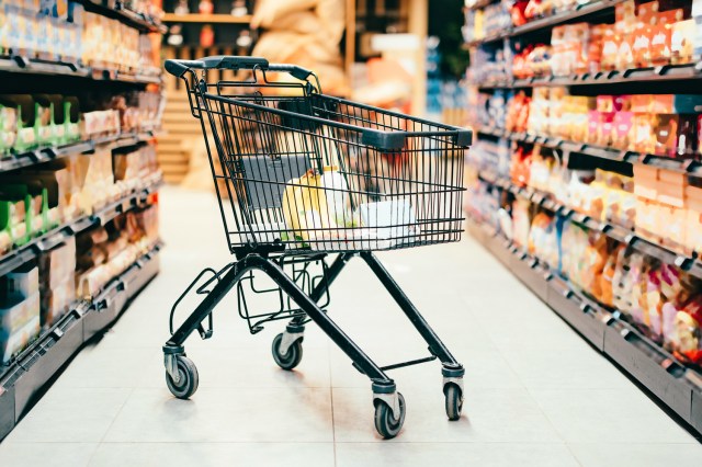 An image of a shopping cart in a grocery store aisle