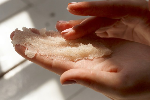 An image of a person with a salt scrub in their hand