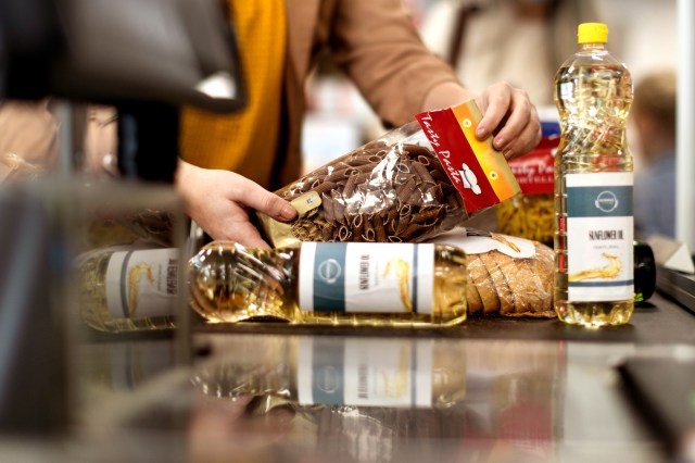 An image of groceries on a register conveyor belt