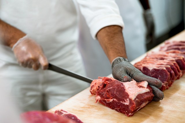 An image of a butcher cutting meat