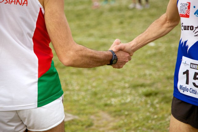 An image of two runners shaking hands