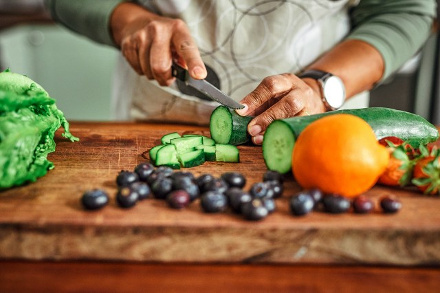 An image of a person cutting vegetables