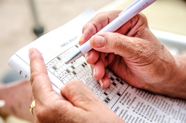 An image of a person doing a crossword puzzle