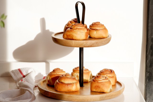 An image of cinnamon rolls on a tiered serving dish