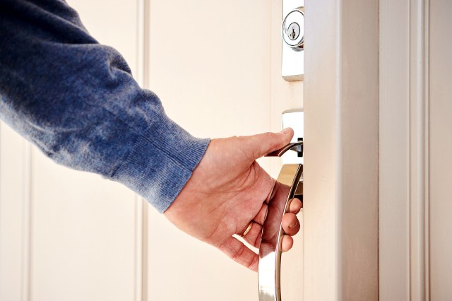 An image of a person opening a door